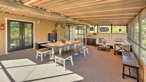 An open-plan living area with a dining table, benches, and seating. - Jackson Escape w/ Hot Tub & Mtn Views! (Jackson)