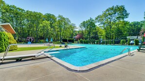 A rectangular swimming pool with a metal ladder on one side, surrounded by a concrete deck. - ~ 1 Mi to Lake: Secluded Poconos Home w/ Decks (Jim Thorpe)