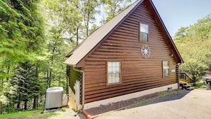 A wooden cabin with a sloped roof, a window with blinds, and a small porch. - Sevierville Cabin w/ Hot Tub, Views & Pool Access! (Sevierville)