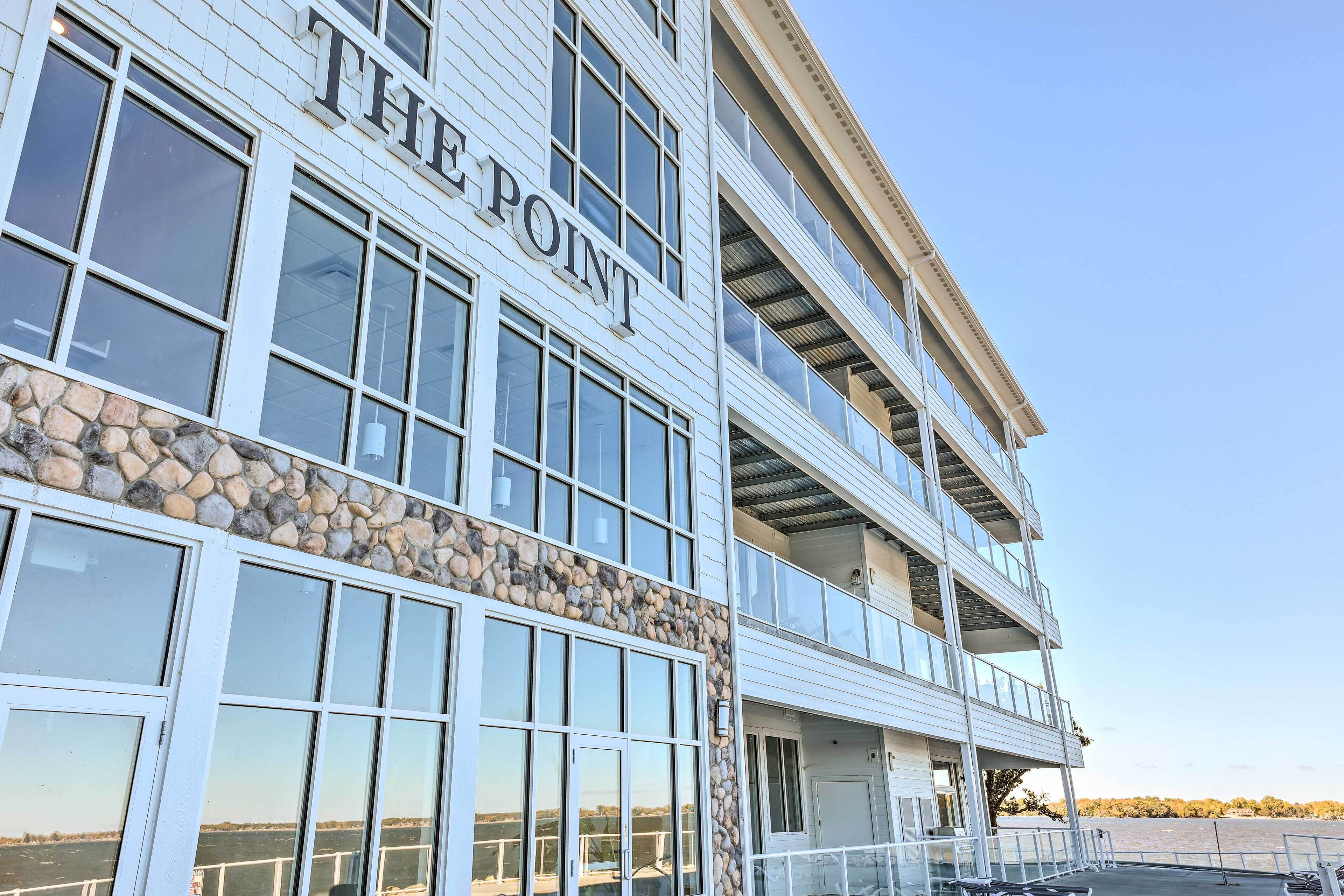 A multi-story building with a stone facade and large windows.
