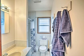 A bathroom with a bathtub, toilet, and a window. - Secluded Getaway < 10 Mi to Saratoga Springs! (Greenfield Center)