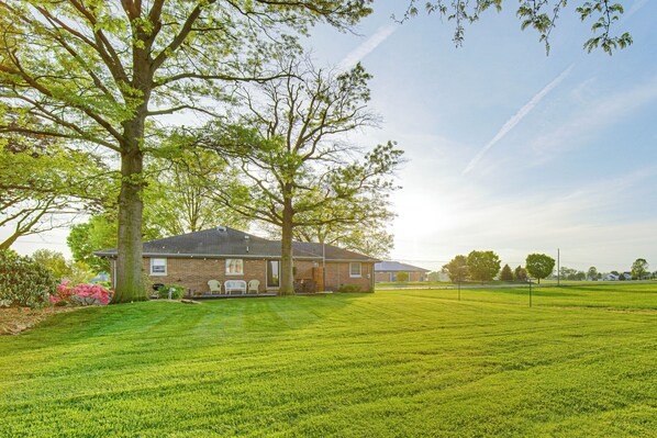 A residential property with a well-maintained lawn, a large tree, and a brick house. - 3 Mi to Dutch Wonderland: Serene Home w/ Deck (Lancaster)