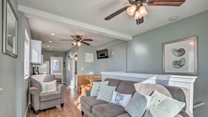 A living room with a gray sofa, a gray armchair, and a ceiling fan. - York Beachfront Condo - Steps to Long Sands! (York Beach)