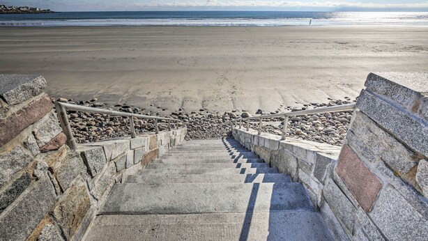 A staircase leading to a beach with a clear view of the ocean. - York Beachfront Condo - Steps to Long Sands! (York Beach)