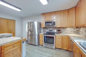 Equipped with a refrigerator, microwave, and oven, this kitchen offers a clean and contemporary design.