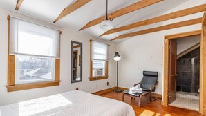 A bedroom with a bed, a chair, a desk, and a window. - Home of the Braves - Bradley Campus Suite (West Peoria)