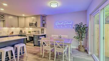 Enjoy cooking in this kitchen with a sleek island, bar stools, microwave, and ample counter space.