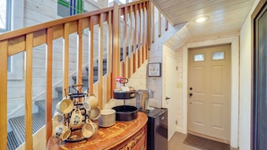 A wooden staircase with a handrail, a coffee station with mugs and a kettle, and a door with a window. - Beech Mountain Cabin w/ Deck: Half-mi to Skiing (Banner Elk)