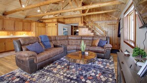 A spacious living room with a large sectional sofa, a wooden ceiling, and a staircase leading to another level. - 'away at Moose Bay' Breezy Point Gem w/ Game Room (Pequot Lakes)