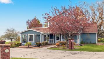 A single-story house with a front porch, a garage, and a well-maintained lawn.