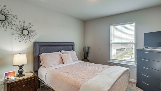 A bedroom with a bed, nightstand, lamp, dresser, and a window with blinds. - 'camden Ocean Springs' House Near Beaches! (Ocean Springs)