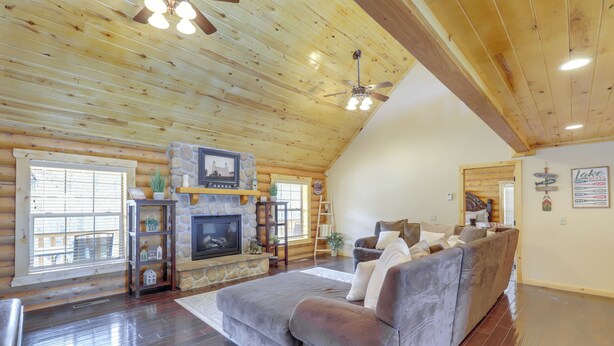 A log cabin interior with a stone fireplace, a sofa, and a ceiling fan. - Large Sterling Cabin < 1 Mi to Palisade State Park (Sterling)
