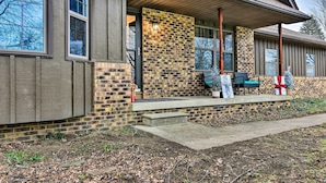 A modern building with a brick facade, large windows, and a covered porch area. - 14 Mi to Frankenmuth: Apt on 3 Acres in Clio! (Clio)