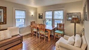 A living room with a wooden dining table, two sofas, and a lamp. - Bridgeport Vacation Rental - Walk to Beach! (Bridgeport)