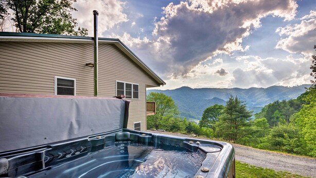 A hot tub with a view of mountains and a house in the background. - Blue Ridge Mountain Rental w/ Hot Tub & Gas Grill! (Marshall)