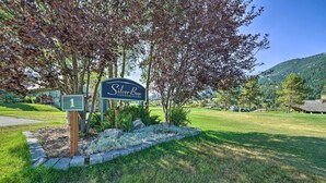 A sign for Silver Bow Condominiums with a number 1 marker, surrounded by a landscaped area with grass and trees. - Big Sky Condo w/ Resort Amenities & Mountain Views (Big Sky)