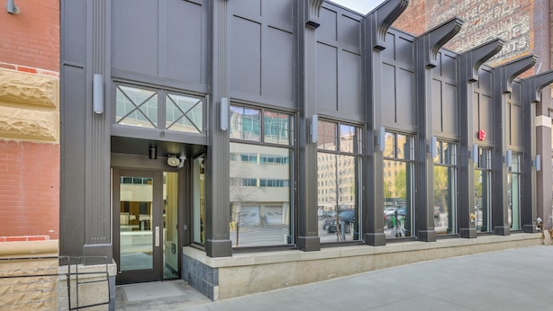 A modern building with large windows and a brick facade. - Downtown Omaha Getaway w/ Deck & Gas Grill! (Omaha)
