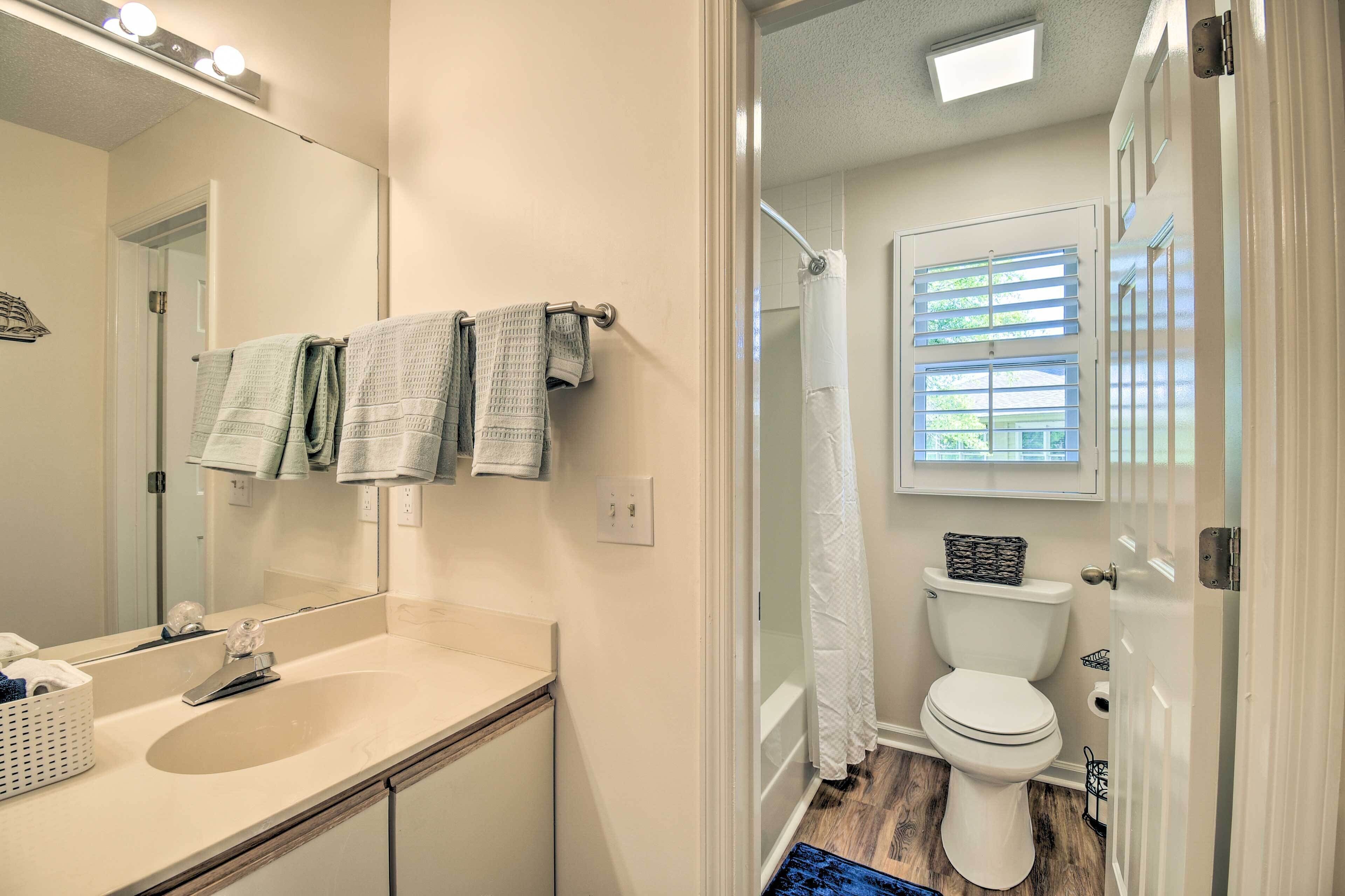 A bathroom with a sink, mirror, and toilet.