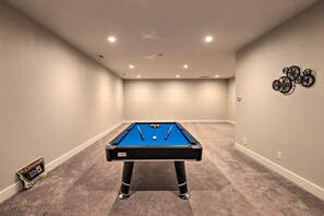 A pool table in a room with carpeted flooring and recessed lighting on the ceiling. - Luxe Asheville Home w/ Stunning Mountain Views! (Asheville)
