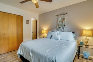 A bedroom with a bed, wooden wardrobe, wall-mounted lamps, and a ceiling fan. - Mom's Place in Jemez - 1 Mi to Hot Spring (Jemez Springs)