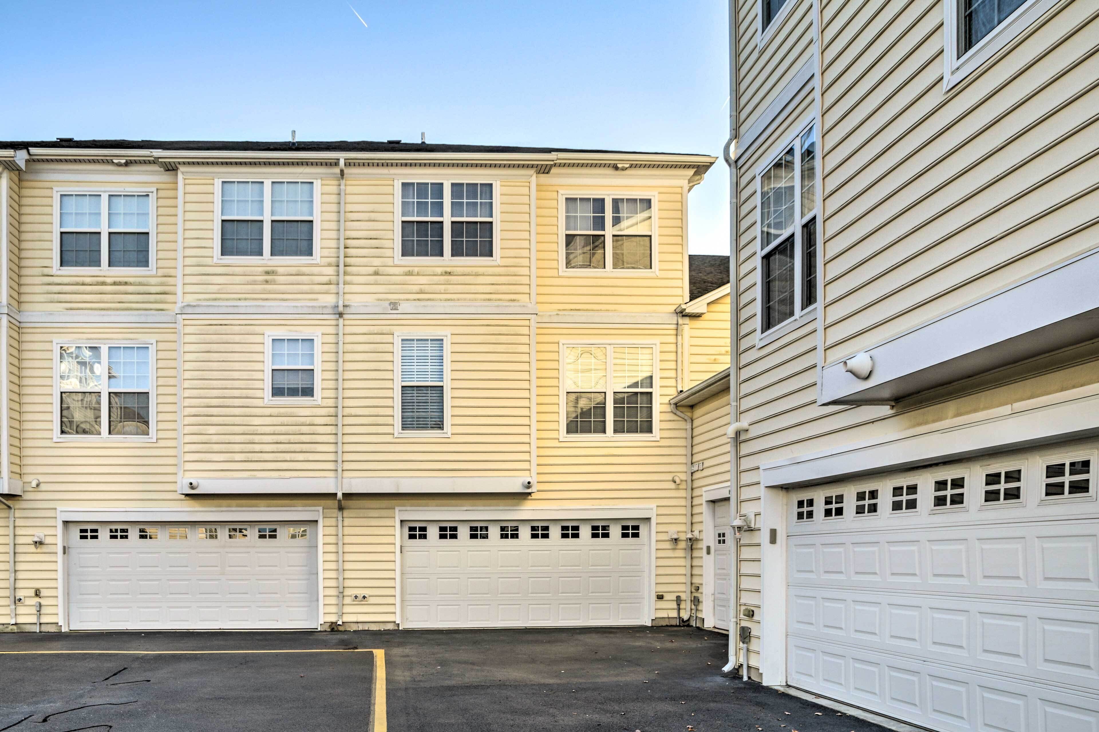 A two-story building with a garage and a driveway.