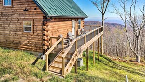 A log cabin with a deck and outdoor seating, surrounded by a forested landscape. - Peaceful Free Union Cabin w/ Deck & Mtn Views (Dyke)