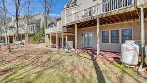 A residential area with multiple houses, a covered porch, and a propane tank. - Community Perks & Deck: Lake Harmony Townhome! (Lake Harmony)