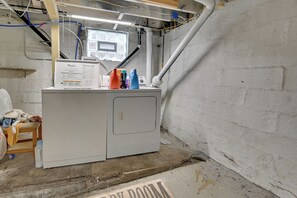 A laundry room with a washing machine, a small table with cleaning supplies, and a window. - Pittsburgh Home Near Frick Park, 7 Mi to Dtwn (Pittsburgh)