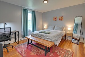 A bedroom with a bed, a desk, a chair, a mirror, and a window with curtains. - Pittsburgh Home Near Frick Park, 7 Mi to Dtwn (Pittsburgh)