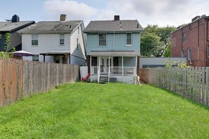 A residential property with a fenced backyard, a porch, and a garage. - Pittsburgh Home Near Frick Park, 7 Mi to Dtwn (Pittsburgh)