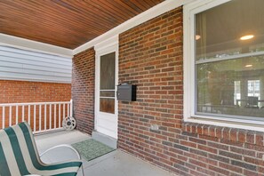 A covered porch with a brick wall, a white door, and a window. - Pittsburgh Home Near Frick Park, 7 Mi to Dtwn (Pittsburgh)