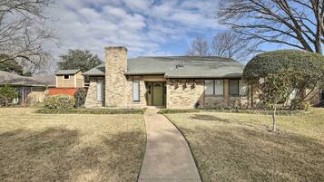 Stroll up to this charming home with a brick exterior, complete with a cozy chimney and attached garage.