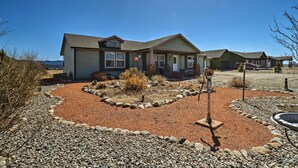 A single-story house with a front yard featuring a rock garden and a small tree. - 'the Fishing House' Buena Vista Home w/ Mtn Views! (Buena Vista)