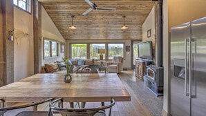 A spacious kitchen with a large island, stainless steel appliances, and a ceiling fan. - Updated Cabin w/ Hot Tub ~ 11 Mi to Winter Park! (Winter Park)