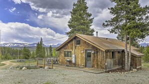 A rustic wooden cabin with a deck, a door, and a window. - Updated Cabin w/ Hot Tub ~ 11 Mi to Winter Park! (Winter Park)