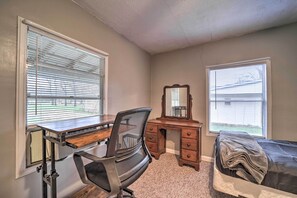 A bedroom with a desk, chair, dresser, mirror, and a bed. - Unplugged Bryson City Cabin Near Downtown (Bryson City)