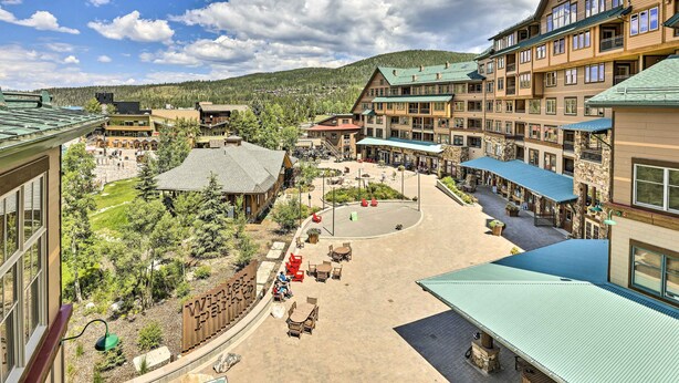 A resort with multiple buildings, outdoor seating areas, and a central courtyard. - Winter Park Condo w/ Mountain Views + Hot Tub (Winter Park)