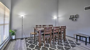 A dining area with a table and chairs, a floor lamp, and a potted plant. - West San Antonio Home w/ Yard: 16 Mi to Dtwn! (San Antonio)