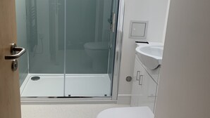 A modern bathroom with a glass-enclosed shower, a white toilet, and a sink. - Stag & Thistle Hotel and Restaurant (Fraserburgh)