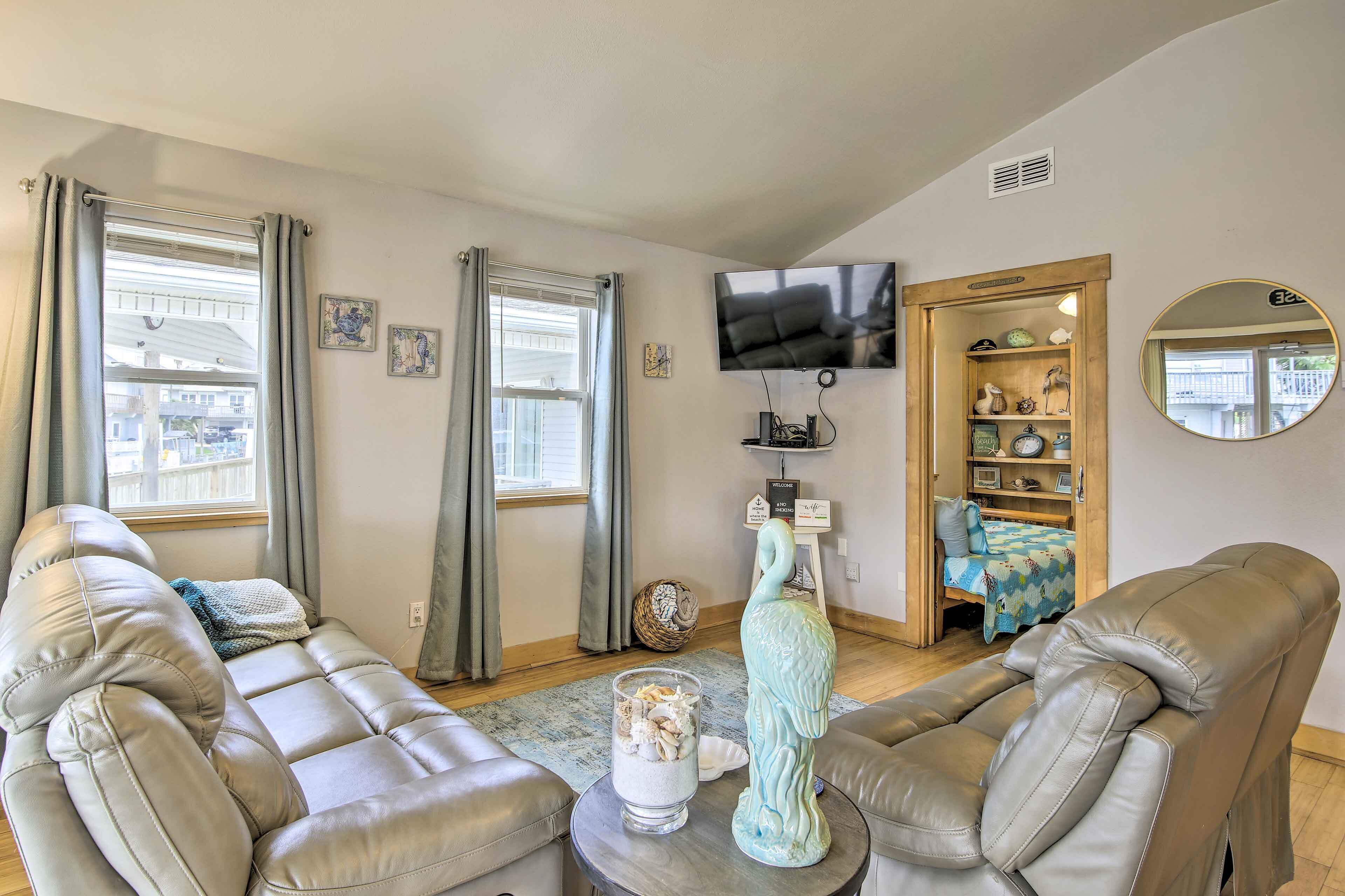 A living room with a sofa, a coffee table, a TV, and a bookshelf.