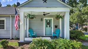 A house with a porch, two chairs, an American flag, and a wreath on the door. - Chic Charlotte Retreat < 3 Miles to Downtown! (Charlotte)