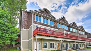 A multi-story building with a red balcony, multiple windows, and a front porch. - Getaway Chalet in Mars Hill w/ Hot Tub & Views! (Mars Hill)