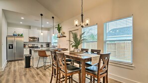A modern kitchen with stainless steel appliances, wooden dining table, and chairs. - 4 Mi to Boat Ramp: Charming Rockport Home (Rockport)