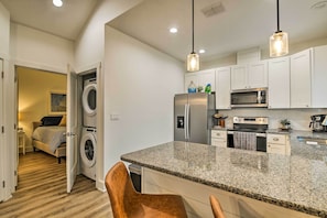 A compact kitchen with granite countertops, stainless steel appliances, and pendant lighting. - 4 Mi to Boat Ramp: Charming Rockport Home (Rockport)