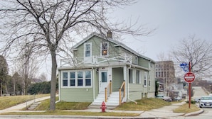 A two-story house with a front porch and a red fire hydrant in front. - Coastal Comfort & Golfers' Paradise in Sheboygan! (Sheboygan)