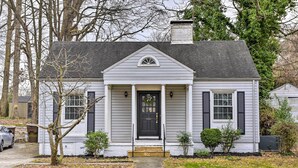 A single-story house with a front porch, a black front door, and a small front yard. - Chic & Cozy Greensboro Home, 2 Mi to Dtwn! (Greensboro)