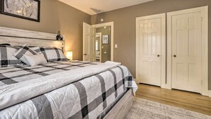 A bedroom with a bed, a ceiling fan, and a door leading to another room. - Chic & Cozy Greensboro Home, 2 Mi to Dtwn! (Greensboro)