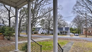 A residential area with a covered porch, stone steps, and a view of neighboring houses. - Chic & Cozy Greensboro Home, 2 Mi to Dtwn! (Greensboro)