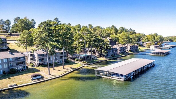 A lakeside property with multiple buildings, docks, and a covered boat launch area. - Hot Springs Vacation Rental w/ Game Room! (Hot Springs)