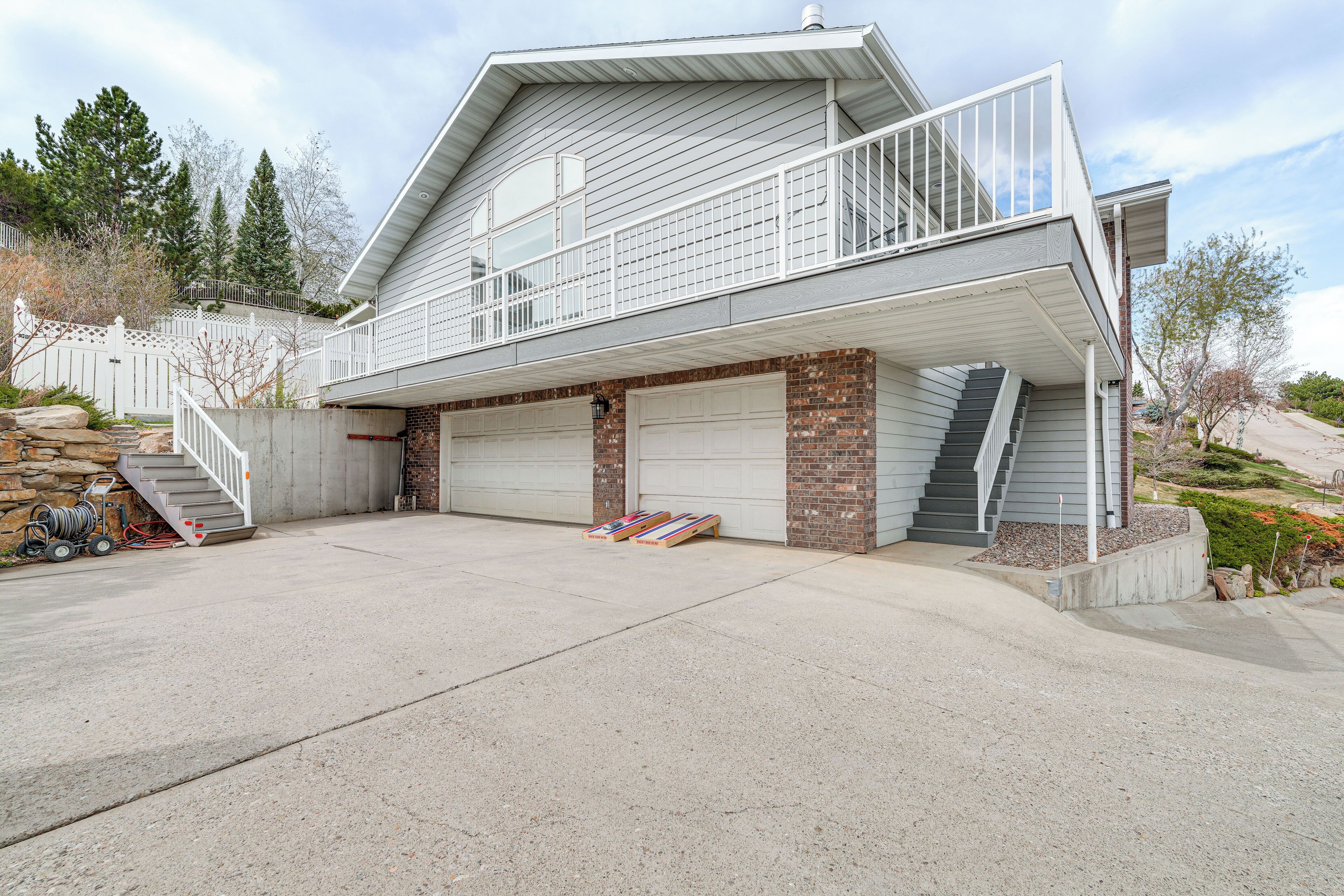 A two-story house with a garage, a balcony, and a staircase leading to the upper floor.